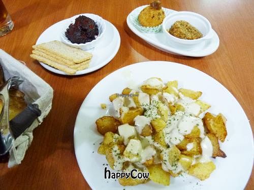 Tapas: potatoes with almond alioli, organic black olive pate, mushroom croquette, rice ball with caramelized onion at Mil Tallos in Zaragoza