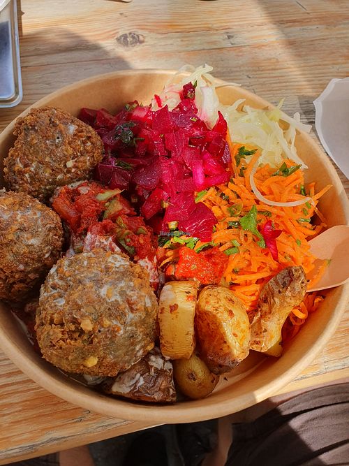 Falafel with cabbage, carrots, hot tomato dish, beetroot and potatoes with tahini sauce at OUNE Falafel in Brussels