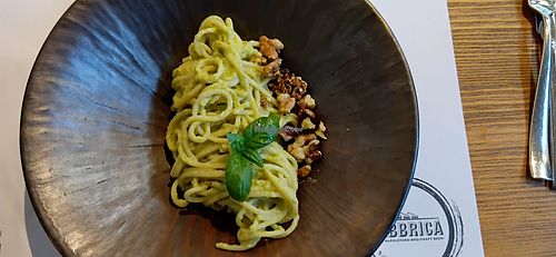 Green pasta (spaghetti dipped in a bit of sauce with a few walnuts) at Fabbrica in Pula