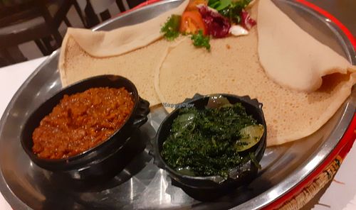 "Yemsir wot" - red lentil stew with red peppers, ginger and garlic, spinach stew "gomen" and injera. Delicious! at Lucy Etiopiska Restaurang in Umea