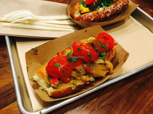 vegan dog on a potato roll with pico de gallo, grilled onions, fresh tomato, guac on a potato bun at Linx in Orange