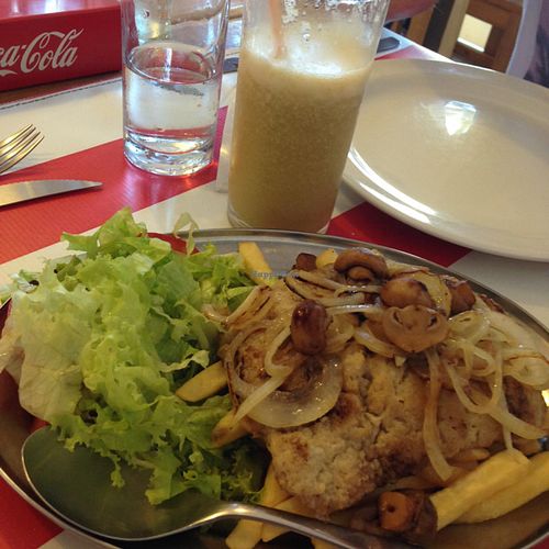 chivita (Uruguayan sandwich) plated version and fruit smoothie at Comida Naturista Irene's in Colonia Del Sacramento
