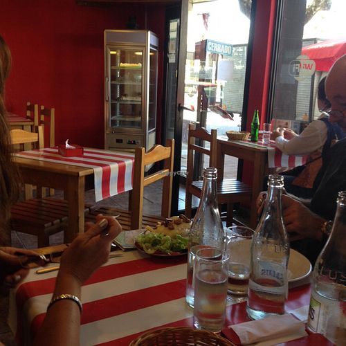 casual, festive small tables at Comida Naturista Irene's in Colonia Del Sacramento