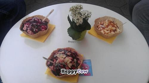 Different ice cream selections at Schlecks, the middle one is vegan - strawberry ice cream with fresh strawberries, almond slices and a dark chocolate topping.  at Schlecks in Osnabruck