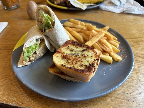 Great imitator wrap with vegan garlic bread and fries  at Nando's - Wilton Rd in South West London