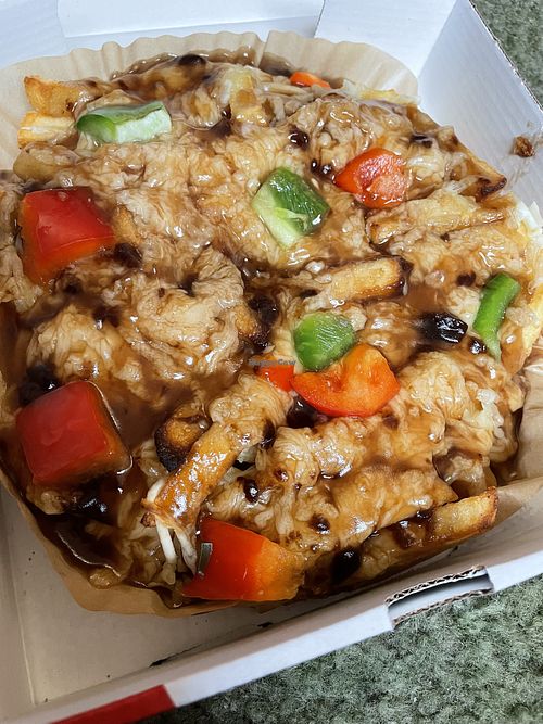 Poutine! Canada’s amazing fries, melted cheese and gravy dish! Looks odd but is delicious!  at Super Singh's in South West London