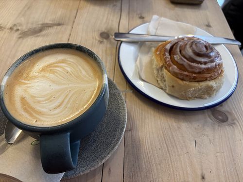 Oat latte & cinnamon bunn  at The Paddle in the Forest in Brockenhurst