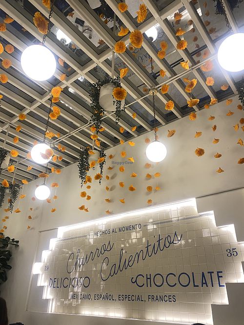 Cozy Interior with a Clear Top y cempasúchil decor   at Churrería El Moro - Coyoacán in Mexico City