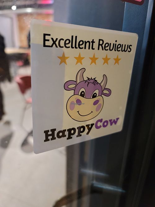 Happycow stickers on wall and counter at Pepas Vegan Frituur in Leuven
