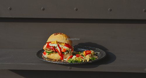 Fondue burger made with vegan home made fondue cheese sauce, sour dough vegan bread, caramelized onion with salad or french fries on the side. at El Exceso Food Truck in Mexico City