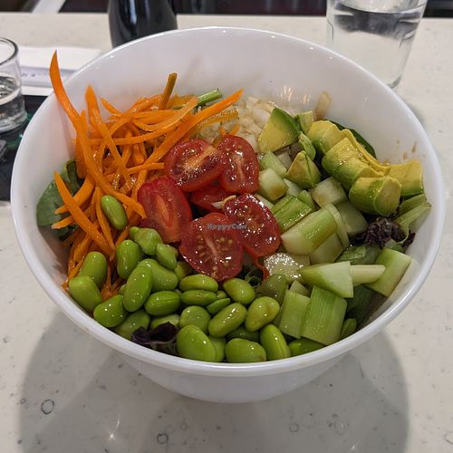 Vegan Bowl: spring mix, carrots, white onion, avocado, cucumber, edamame, tomato, & orange yuzu sauce at Akarui  in Omaha