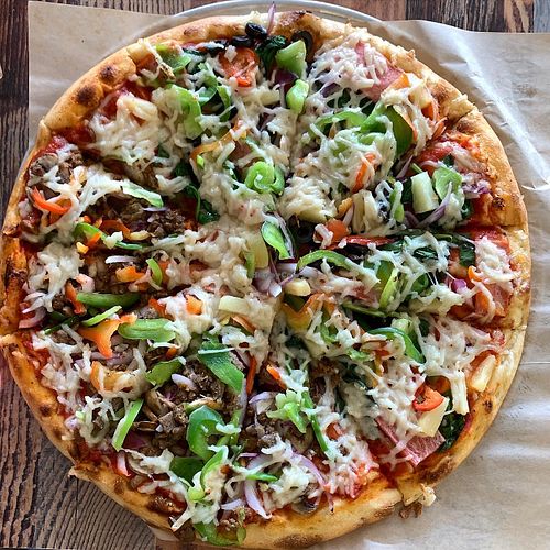 Half Philly cheesesteak half ultimate combo pizza at Vegan Pizza in Garden Grove