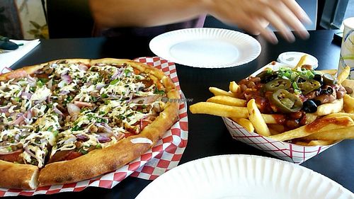 Meat lovers with onions spinach and mushrooms and chili fries at Vegan Pizza in Garden Grove