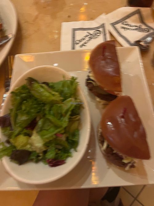 Impossible burger with side of green salad at The Cheesecake Factory in Gainesville
