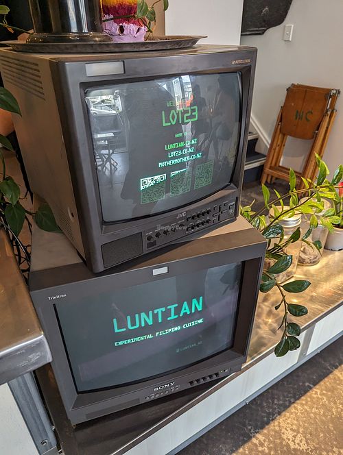 The logo displayed on old school monitors at Luntian in Auckland