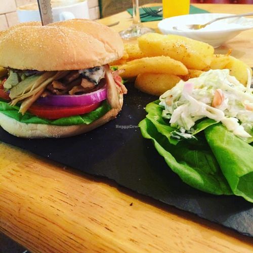 Dirty stop out burger with hot sauce and tzatziki with chips and coleslaw . at Samphire Brasserie in Plymouth