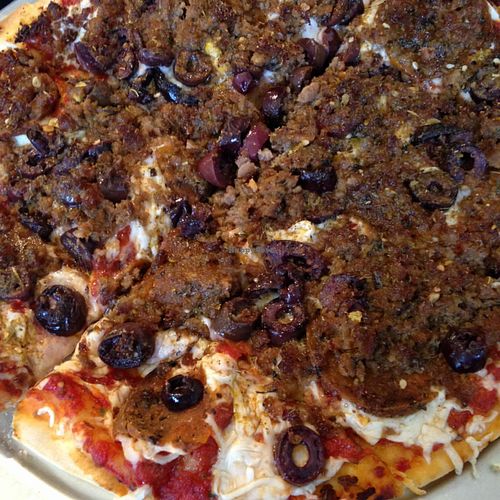 supreme pizza with pepperoni, sausage, and kalamata olives.  at Kitchen 17 in Chicago