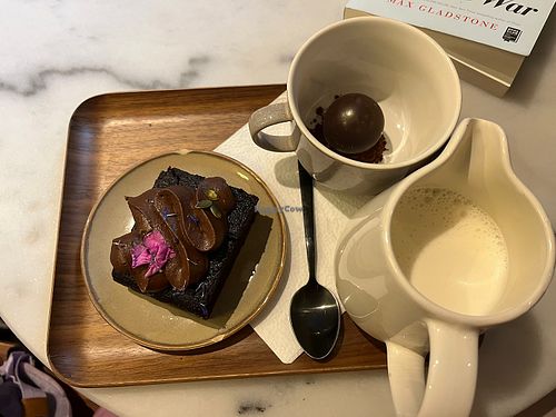 Chocolate cake and hot chocolate with oat milk   at Bloom Café in Lille