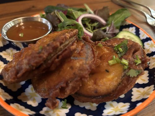 Sliced aubergines kissed with turmeric and
chilli, served with a side salad.  at Delhi 6 Lounge in South Shields