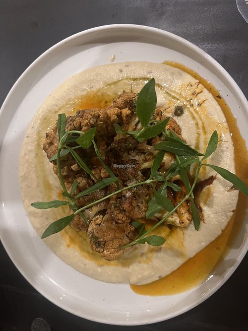 Cauliflower steak served over chickpea puree with chimichurri  at Hideout Lounge in Kandy