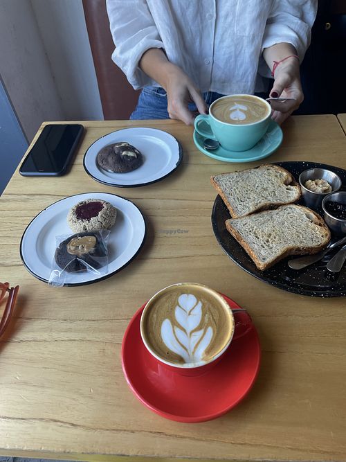 Flat white with almond milk, toast with peanut butter and artesanal jam, vegan cookies  at Negro Mercado in Tandil