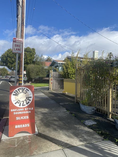 Street Signage Near Outdoor Patio Area  at Nick's Pizza in Oakland