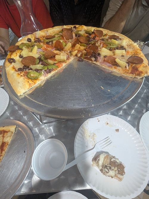 Part of a pizza someone else ordered - I believe it was vegan Greek but she added pineapple and vegan pepperoni at Midtown Pizza in Dallas