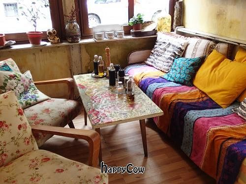 Inside the main dining area there is this cozy little sofa and chairs. Beautiful art on the walls, and delicious food and desserts. at Made In Home in Sofia