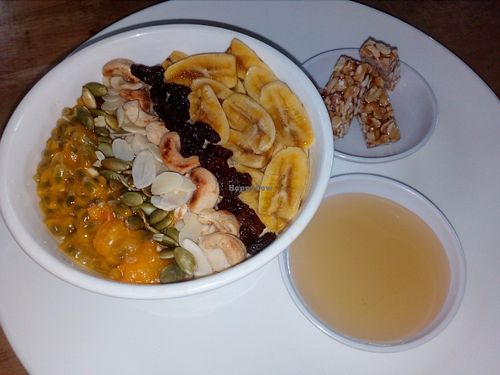 Porridge with bananas, passion fruit, raisins, almonds, pumpkin seeds and cashew nuts. Breakfast superfood in Bamboo Bar & Vegetarian restaurant Sihanoukville at Bamboo Bar & Vegetarian Restaurant in Sihanoukville