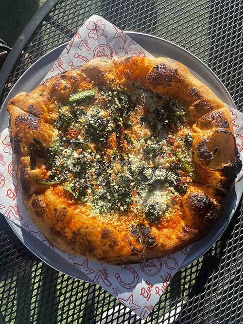 Pizza with broccolini, vegan mozzarella and vegan parmesan cheese .  at Lucky Penny in Santa Barbara