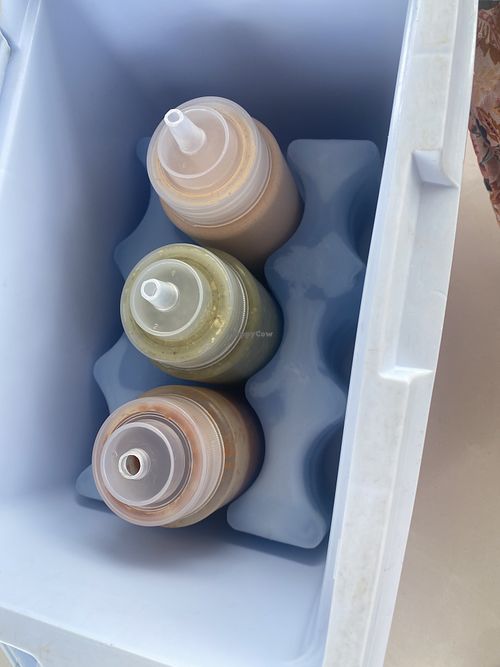 Sauces at the table. Green and red are vegan. Orange is NOT    at Buen Provecho Taco Shack in Guam