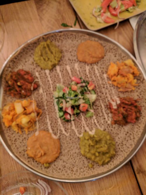 Bayanetu (double dish) - injera bread with variety of spreads/salads at Tenat in Tel Aviv