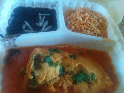 Chile relleno, stuffed with cheese in tomato sauce, with sides of rice, and black beans at El Cantaro Vegan Mexican Restaurant in Monterey