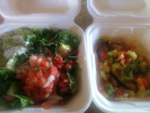 Salad: Spring mixed lettuce with corn, tomatoes, cheese, avocado, tortilla chips, cilantro and ranch jalapeño dressing. And tasty fish taco: vegan tuna with cabbage and mango sals at El Cantaro Vegan Mexican Restaurant in Monterey