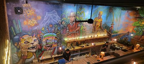 The mural and open kitchen at Somos Ecuador Restaurant in Quito
