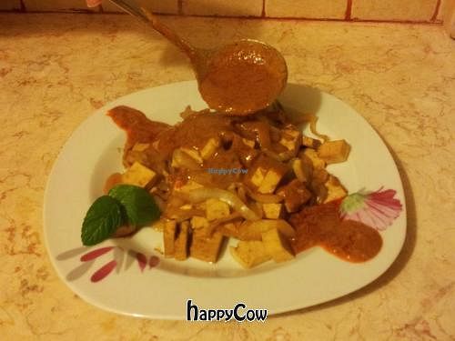 Tofu and onion stir fried in soy sauce and date syrup. Swimming in hot massaman curry and peanuts. at HaMitbach HaTailandi in Pardes Hana