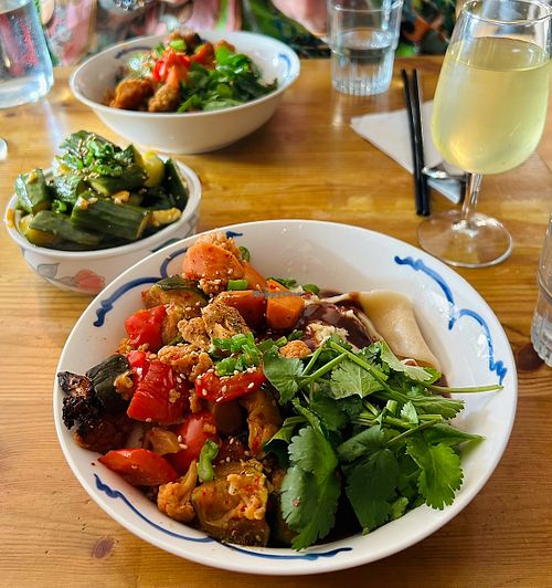 Noodles with peanut chilli sauce and roasted veg. Cucumber, chilli and garlic side    at Pomelo  in Edinburgh