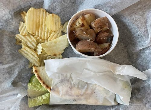 Greek Salad Gyro with roasted potatoes and chips   at Taziki's Mediterranean Cafe in Mobile