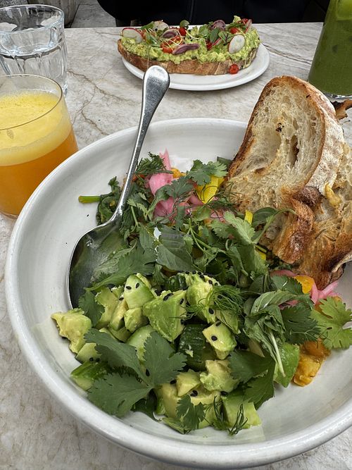 chickpea scramble with fresh squeezed oj, in the background is the avocado toast which is also vegan   at Great White in Venice