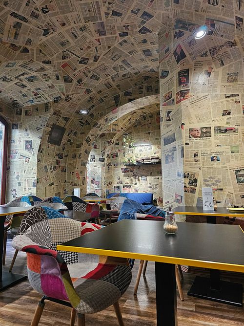 The wallpaper is made out of real newspapers 😯 at Café Localité in Brno