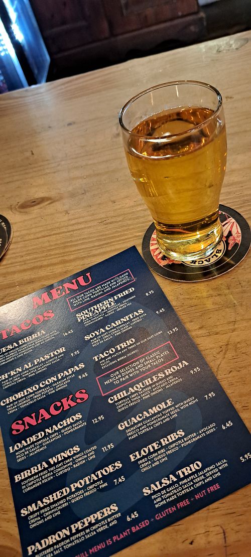 Menu and a half pint of cider at Antojitos in Glasgow