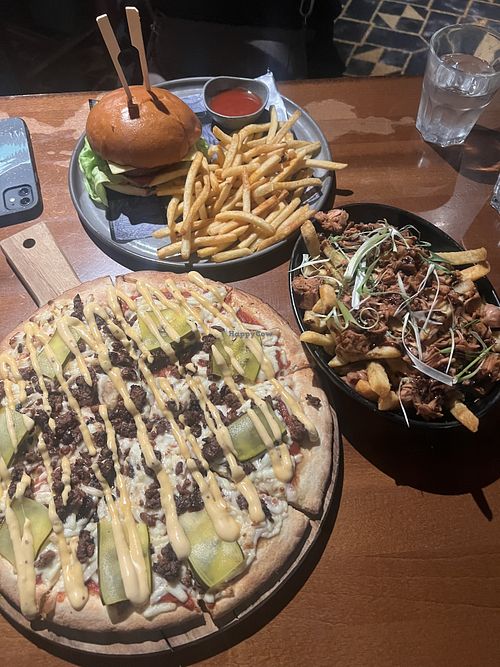 Vegan cheeseburger pizza, vegan burger, and vegan jackfruit fries   at Fortress Sydney in Chippendale