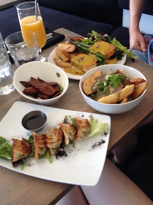 Brunch: Dumplings, side of seitan bacon, and the poutine. The dumplings and seitan were amazing, but the poutine was a bit underwhelming(the potato wedges weren't crispy enough like in the other dishes and the cheese was in very small crumbles...not the nice big curd-like pieces that I saw in other photos). My husband had the benny which was yummy. at enVie A Vegan Kitchen in Halifax