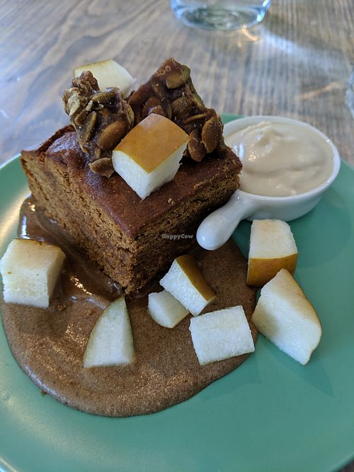 Warm Gingerbread dessert: gingerbread cake, rum sauce, fresh pear, pumpkin brittle, coconut whip at enVie A Vegan Kitchen in Halifax