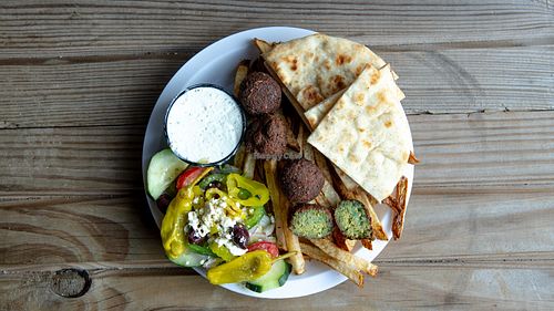 Falafel platter with your choice of side( rice veggies or fresh cut fries) with your choice of sauce (hummus or eggplant) side of salad and a pita bread! at Eat Like A Greek  in Edgewood