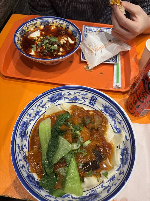Dry noodles with eggplant and tomato, silken tofu in sauce in the back  at Biang Biang - 古城秦味  in Haymarket