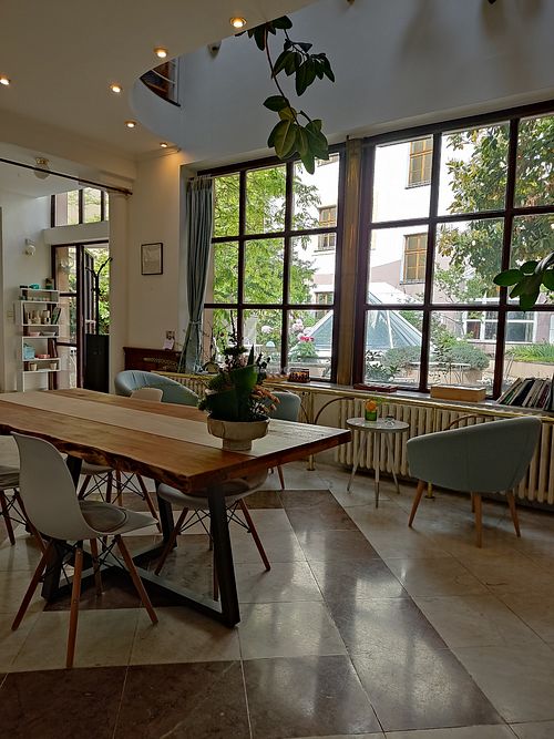Inside with a view of the garden at The Light - Tea House in Prague
