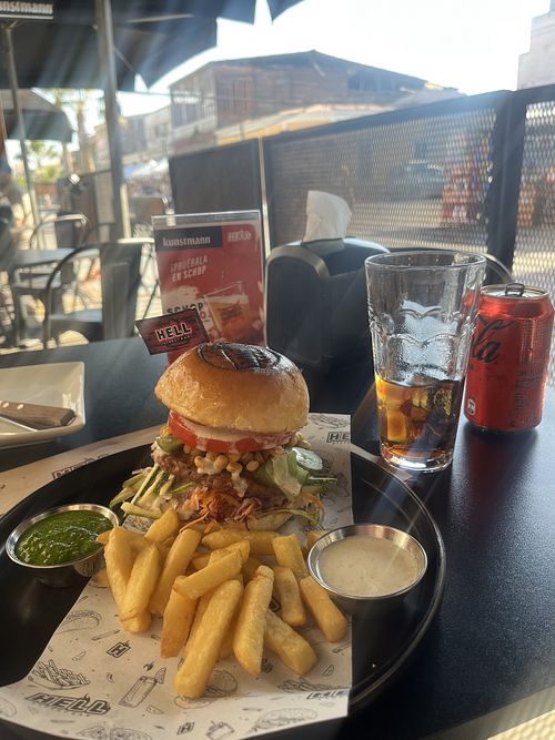 Vegan „beef“ burger, fries are included with two different dips. I asked if everything about it was vegan and they reassured me. It was super tasty and filling!  at Hell Street Bar in Iquique