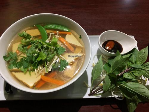 [image description: a colour photo of a bowl of pho on a long plate. beside the bowl is a small bowl with sauces and a bunch of basil. end description.]

Vegetarian Pho - $8.75 (as of October 2014)

absolutely delicious at Veggiebowl in Vancouver