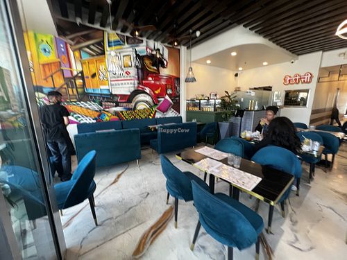 Colorful mural. Comfy seating    at Daddyji in Claremont